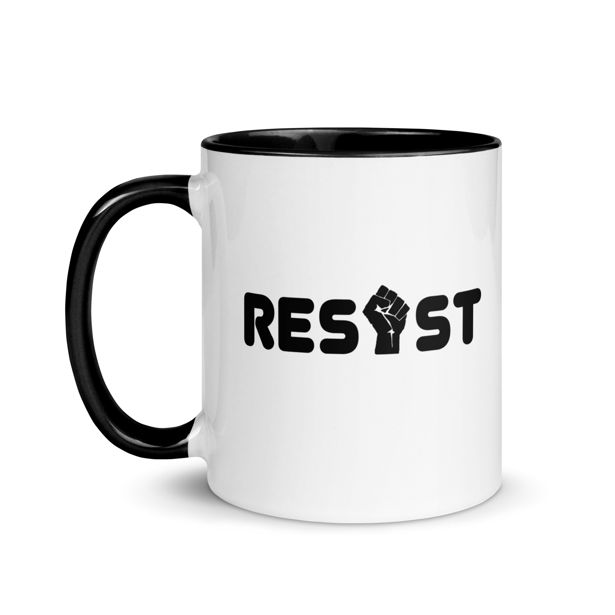 White ceramic mug handle on left with the word Resist but the I is a fist graphic