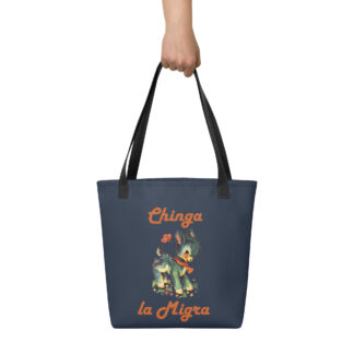 Hand holding navy blue tote bag with black handles with a cute fawn graphic and the words Chinga la Migra