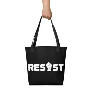 Hand holding a black tote bag with black handles with the word Resist but the I is a fist graphic